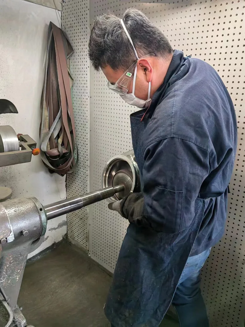 Operator polishing an internal stainless steel surface